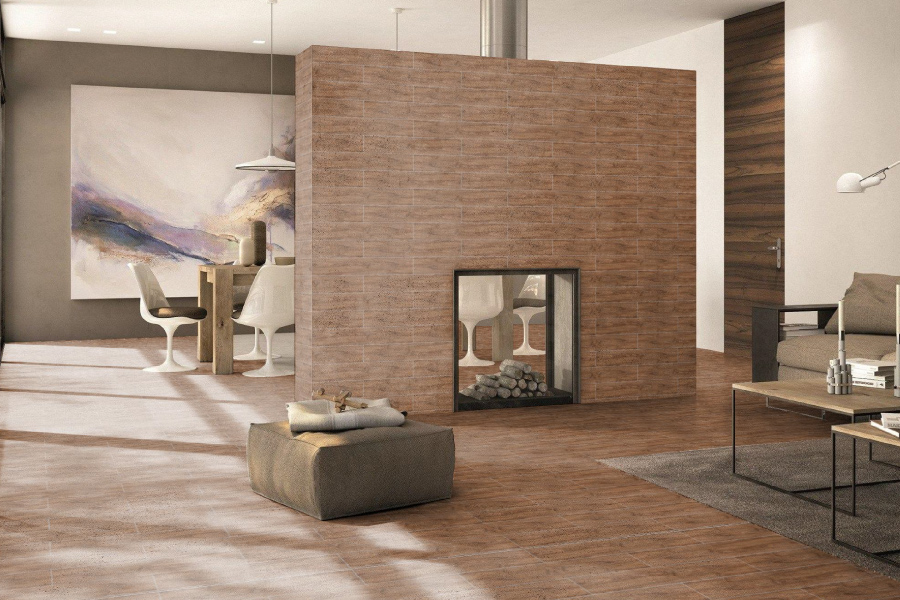 Living room with a Balena wood-look porcelain floor and central fireplace